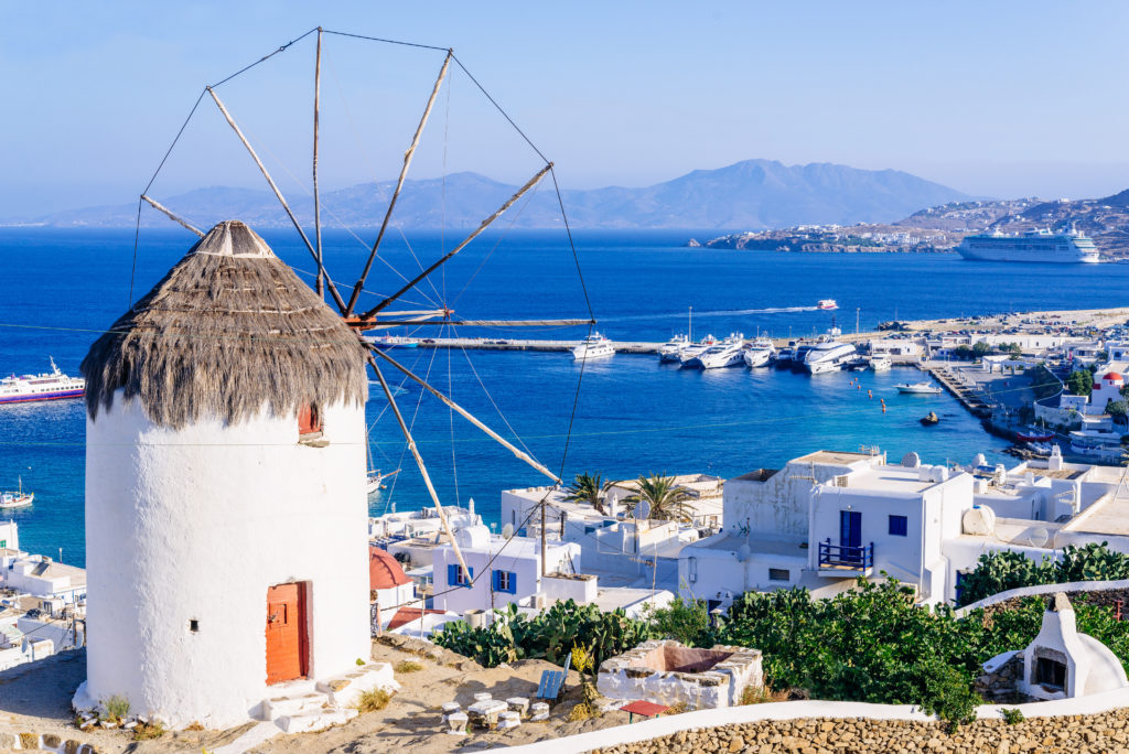 Windmill in Mykonos overlooking the Aegean Sea. Homeric Tours offer holiday packages in Greece.