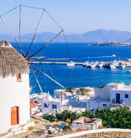 Windmill in Mykonos overlooking the Aegean Sea. Homeric Tours offer holiday packages in Greece.