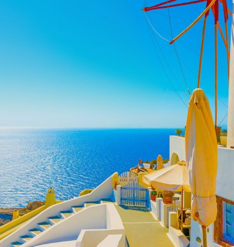 Windmill overlooking the crystal clear sea on one of the Greek islands.