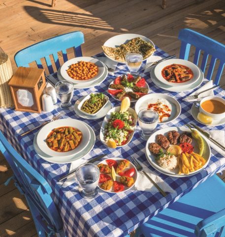 The table is served with Greek delicacies. Tastes of Greece culinary tour holiday.